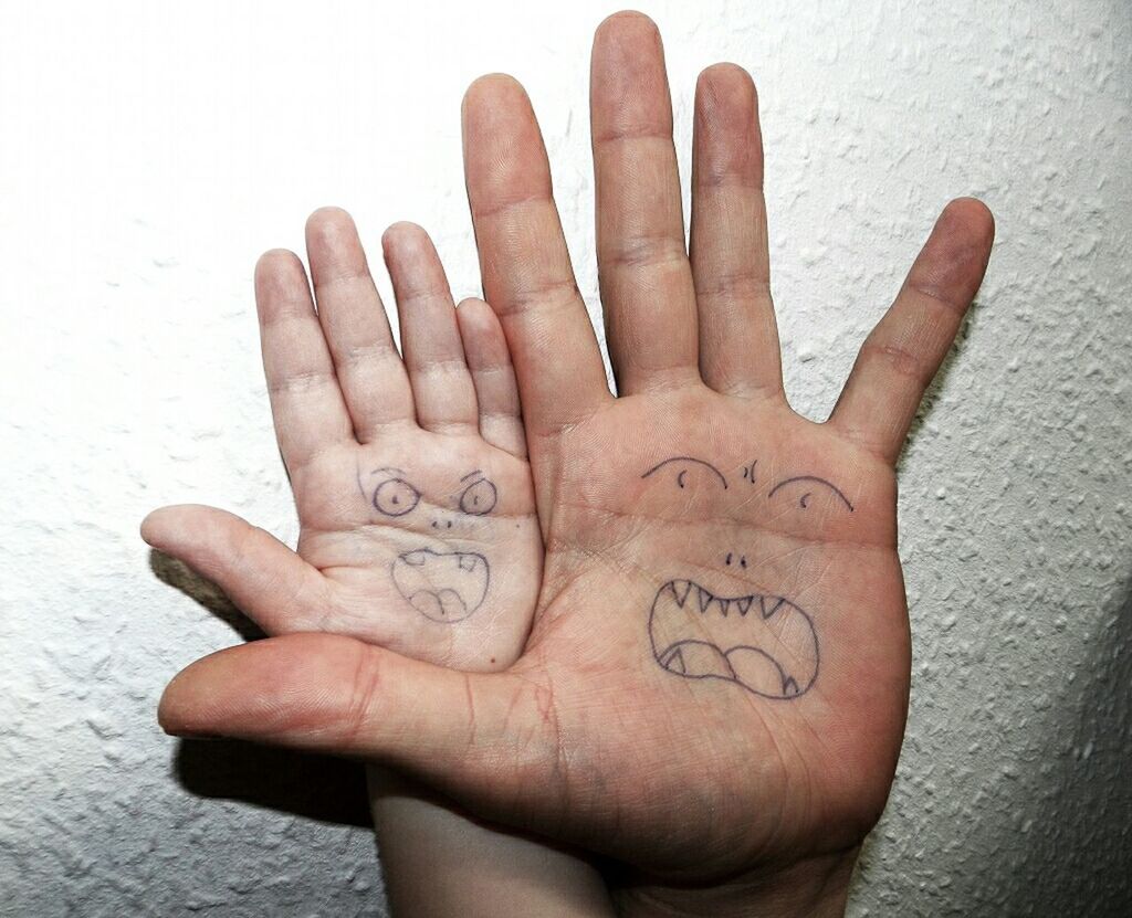 CLOSE-UP OF HUMAN HAND ON WALL