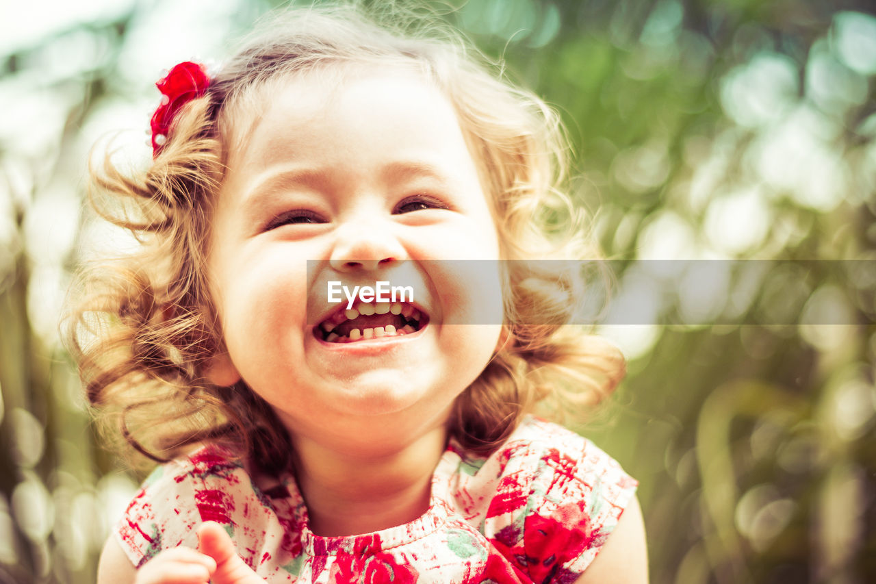 Close-up of cheerful girl on sunny day