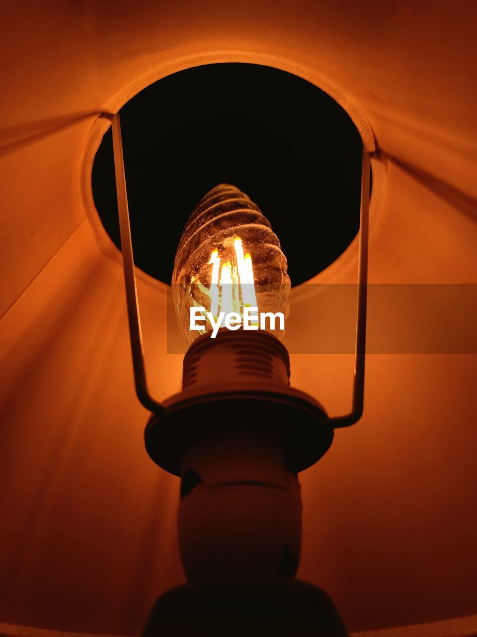 Low angle view of illuminated light bulb