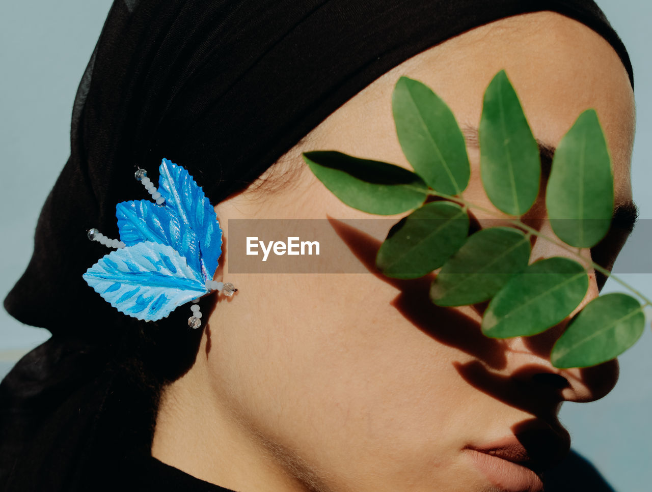 Close-up of woman with leaves