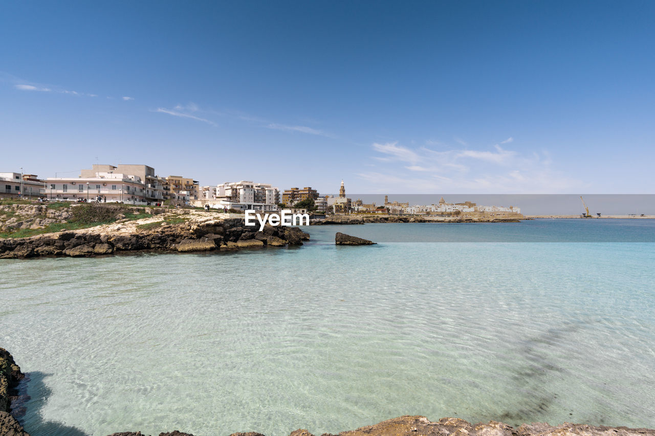 Scenic view of sea against sky in city