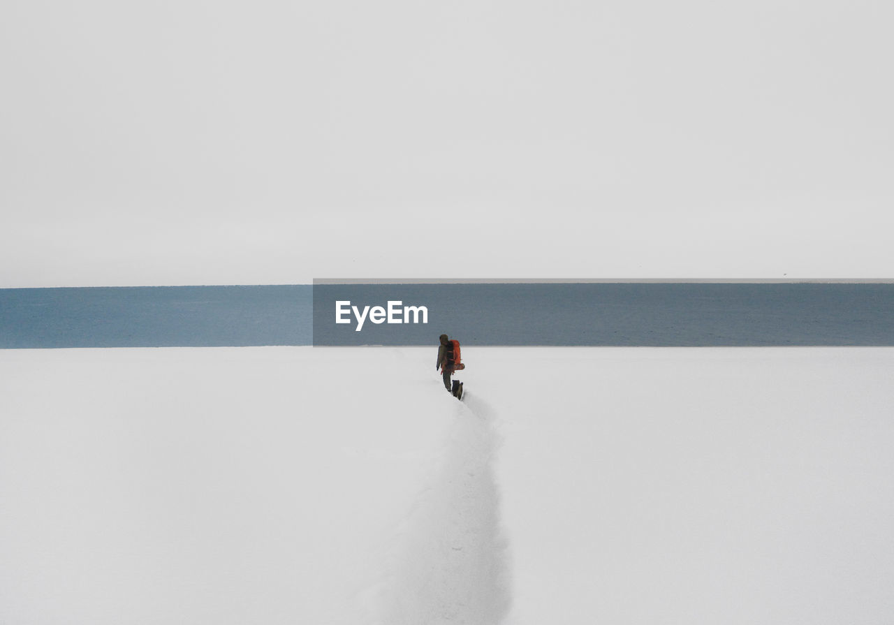 Man on sea against clear sky