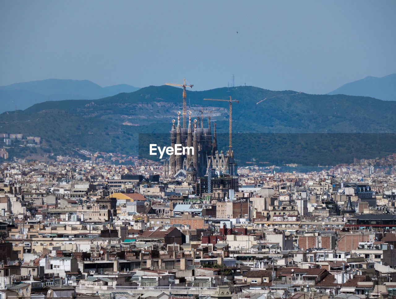High angle view of barcelonas townscape against sky with sagrada familia.