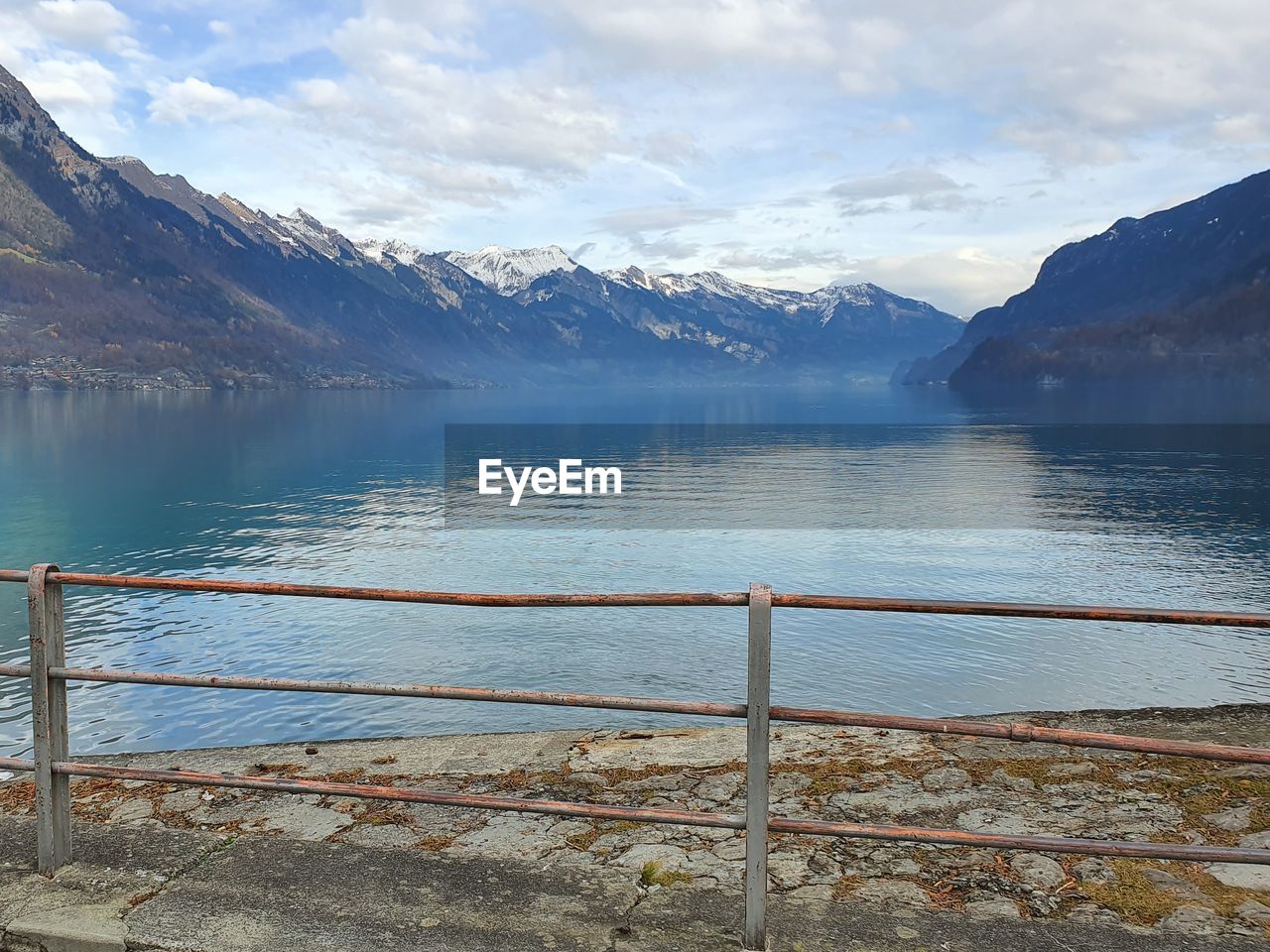 SCENIC VIEW OF LAKE BY MOUNTAIN AGAINST SKY