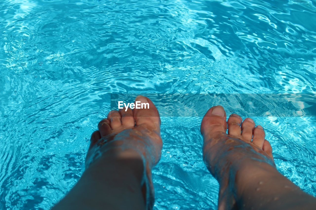 Low section of woman in swimming pool