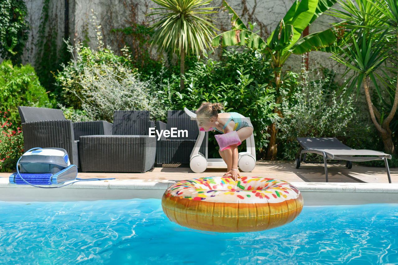 Girl in the pool with an inflatable ring