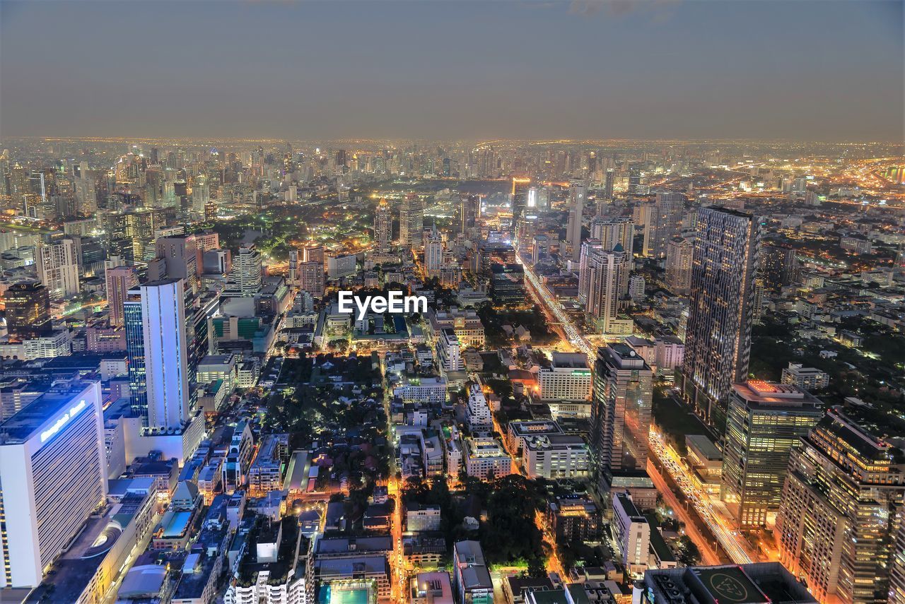 Aerial view of illuminated city buildings at dusk