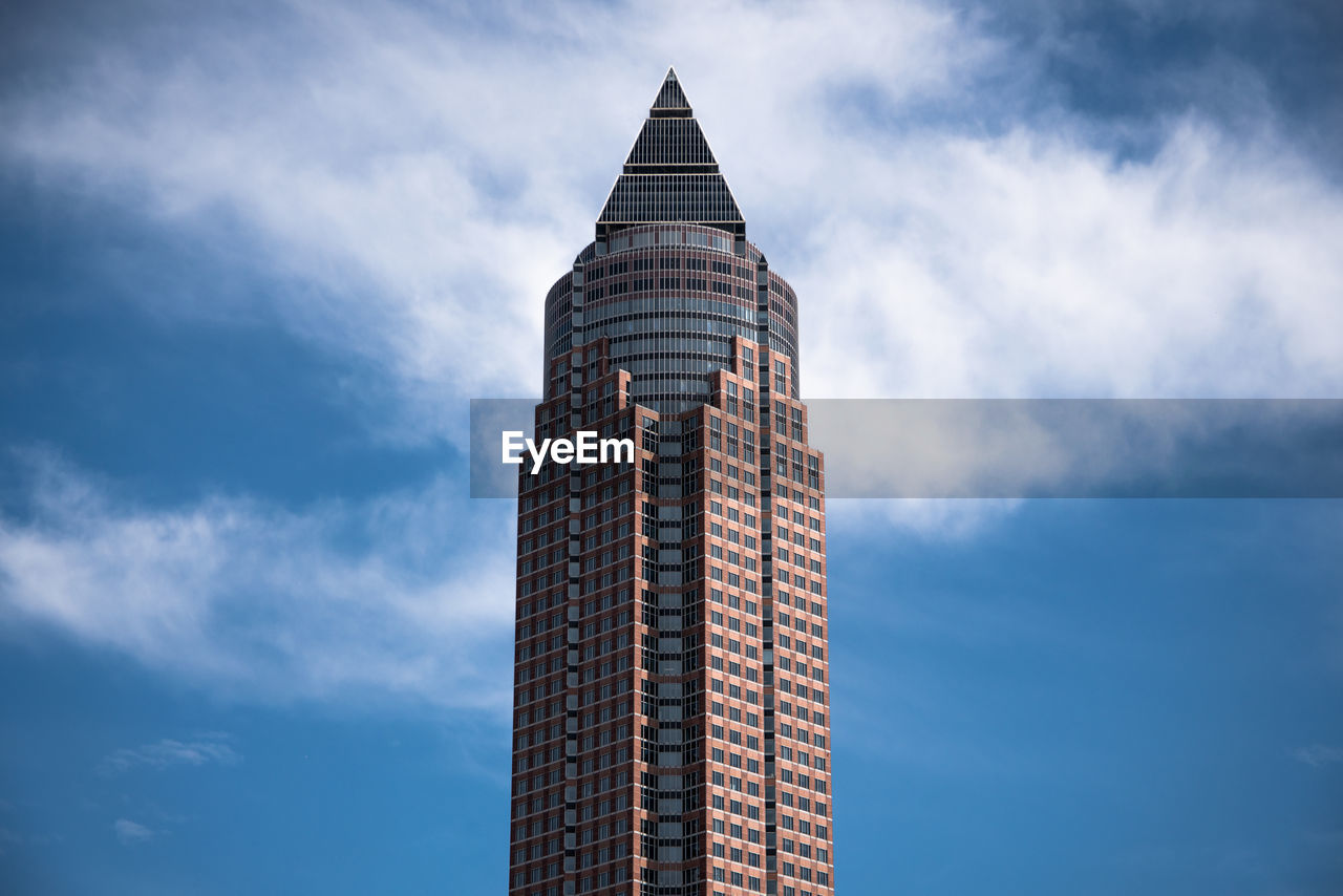 Low angle view of building against cloudy sky