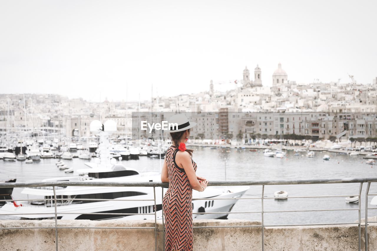 Woman looks at skyline valletta city, malta
