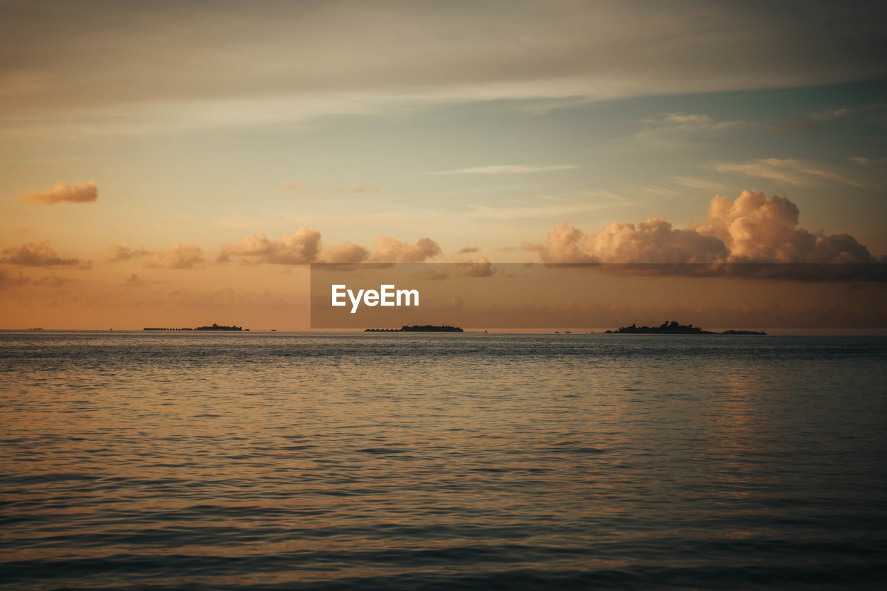 Scenic view of some islands against sky during sunset in the maldives 