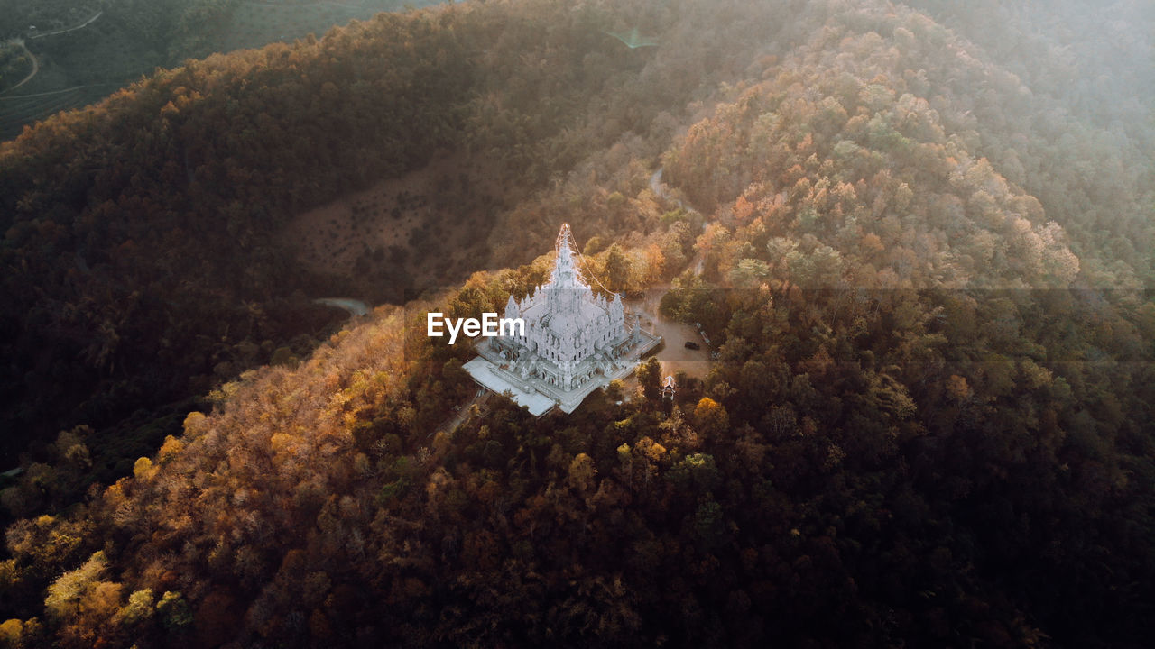 HIGH ANGLE VIEW OF UMBRELLA ON SHORE