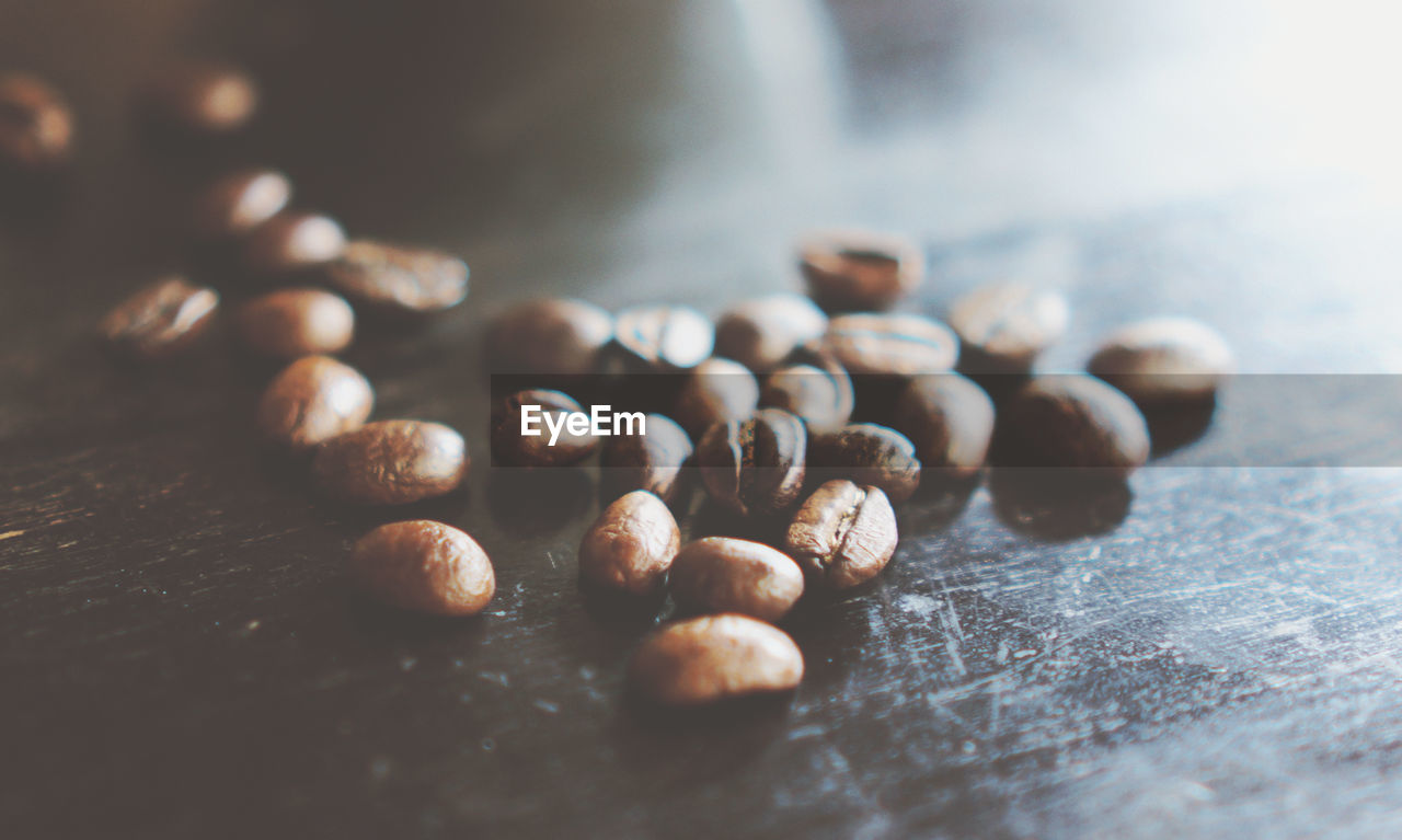 Close-up of roasted coffee beans on table