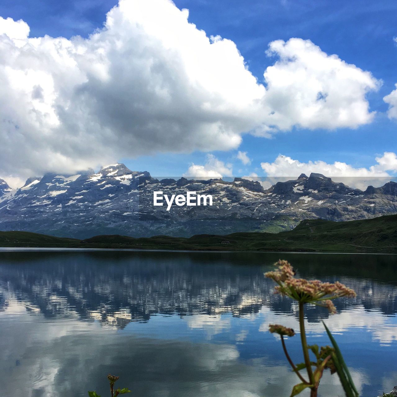 Scenic view of lake and mountains against sky