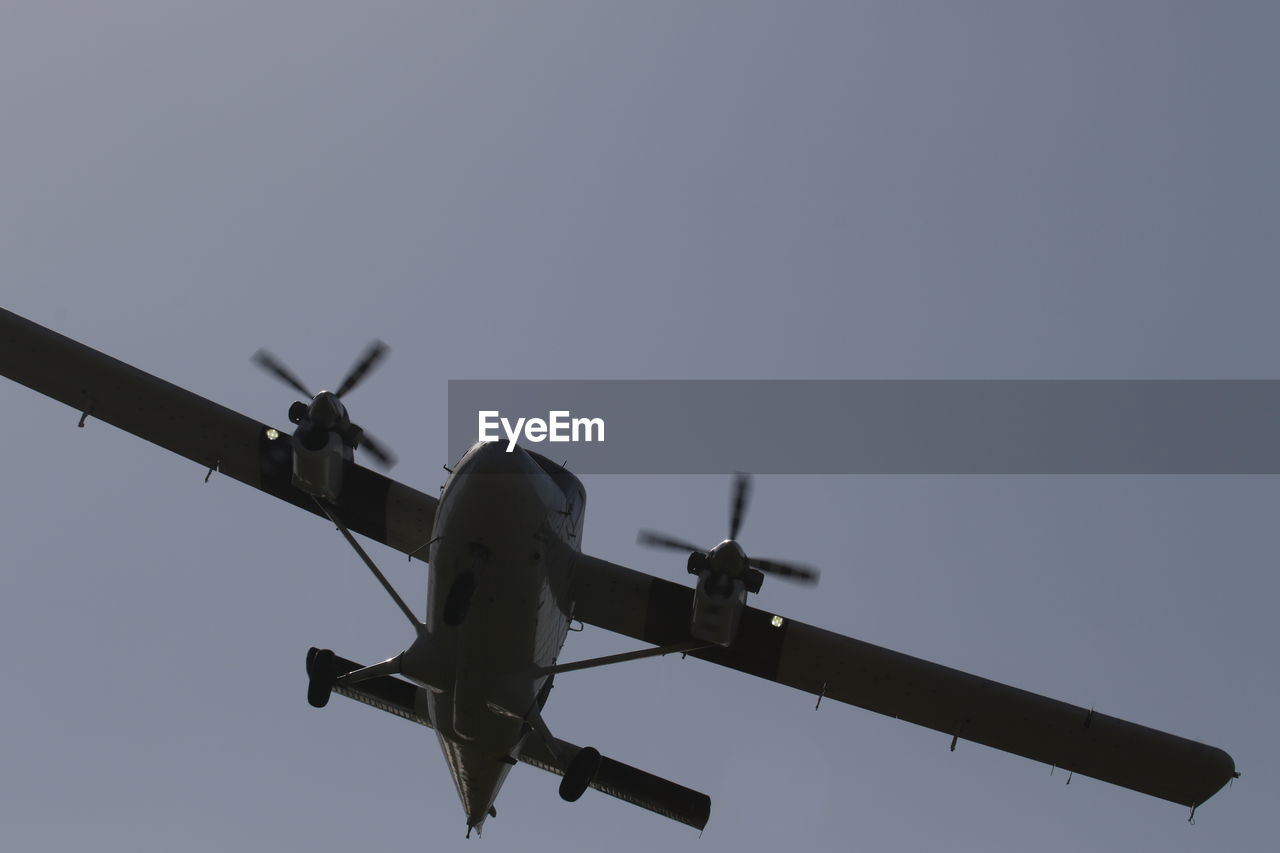 Low angle view of airplane against clear sky