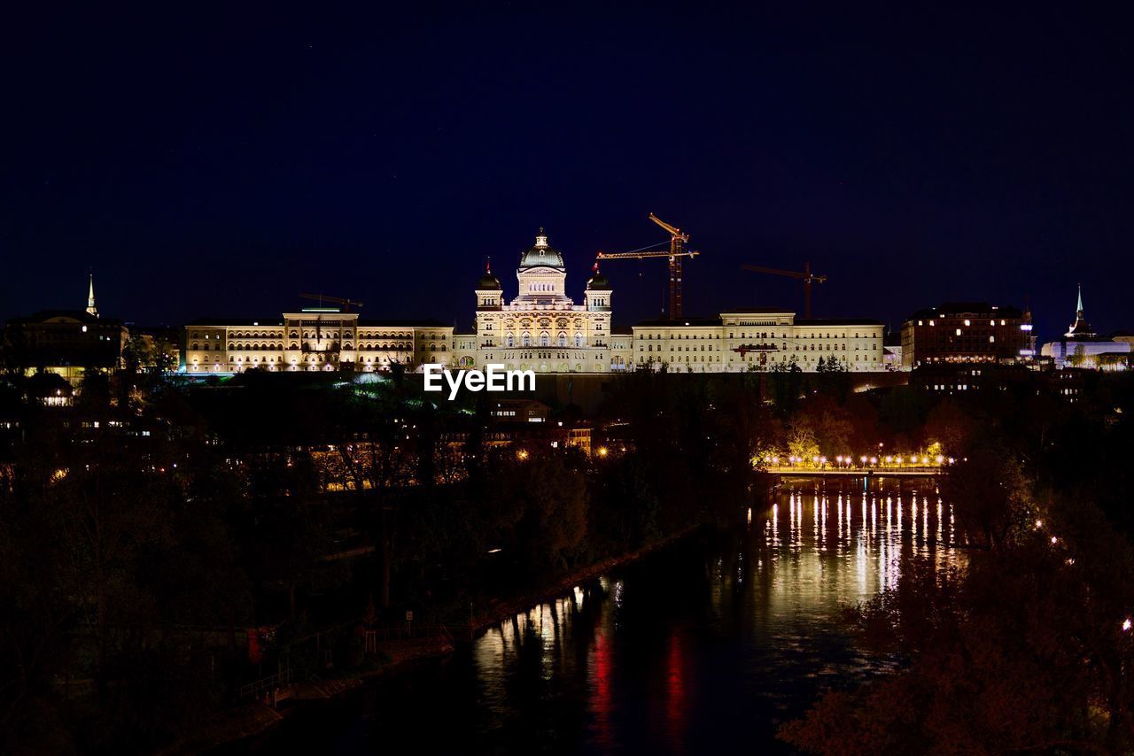 Illuminated city at waterfront