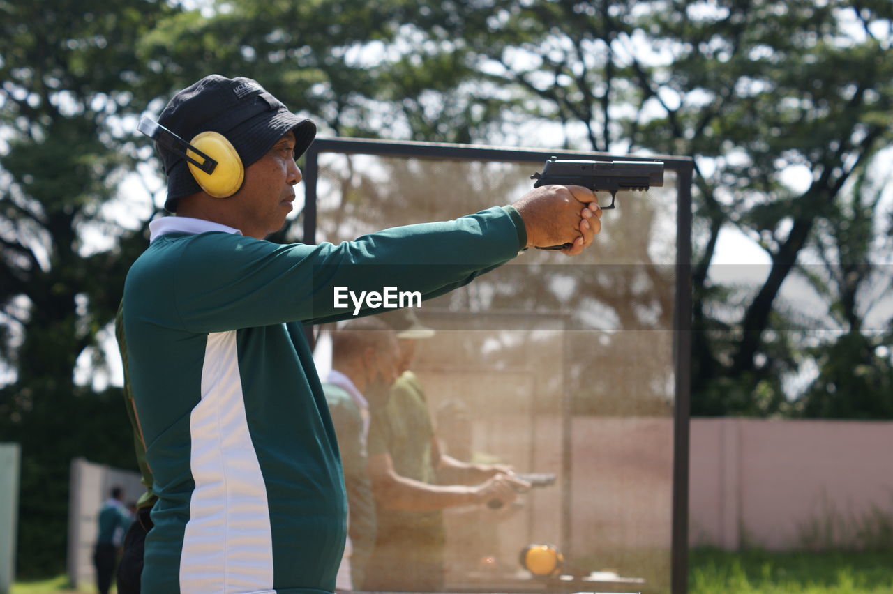 A man standing to shooting on target