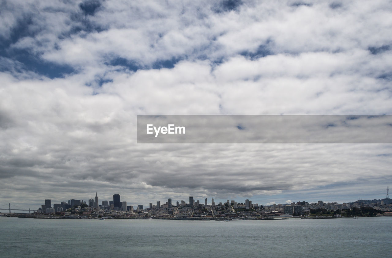 SEA AND BUILDINGS AGAINST SKY