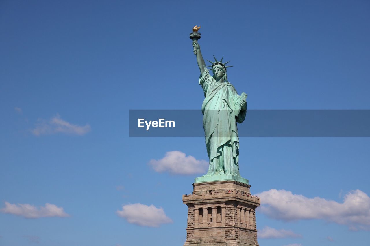 Low angle view of statue of liberty against sky