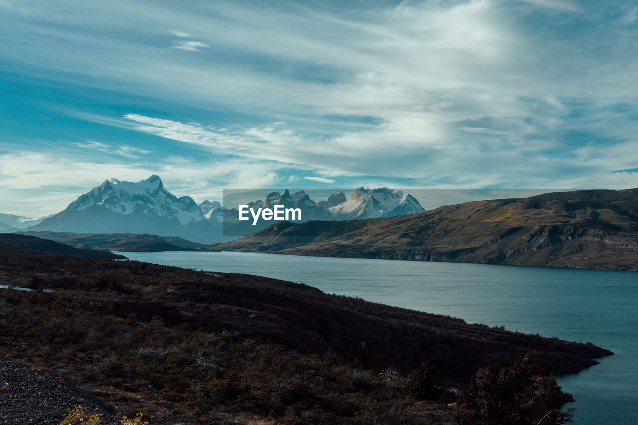 Scenic view of lake and mountains against sky