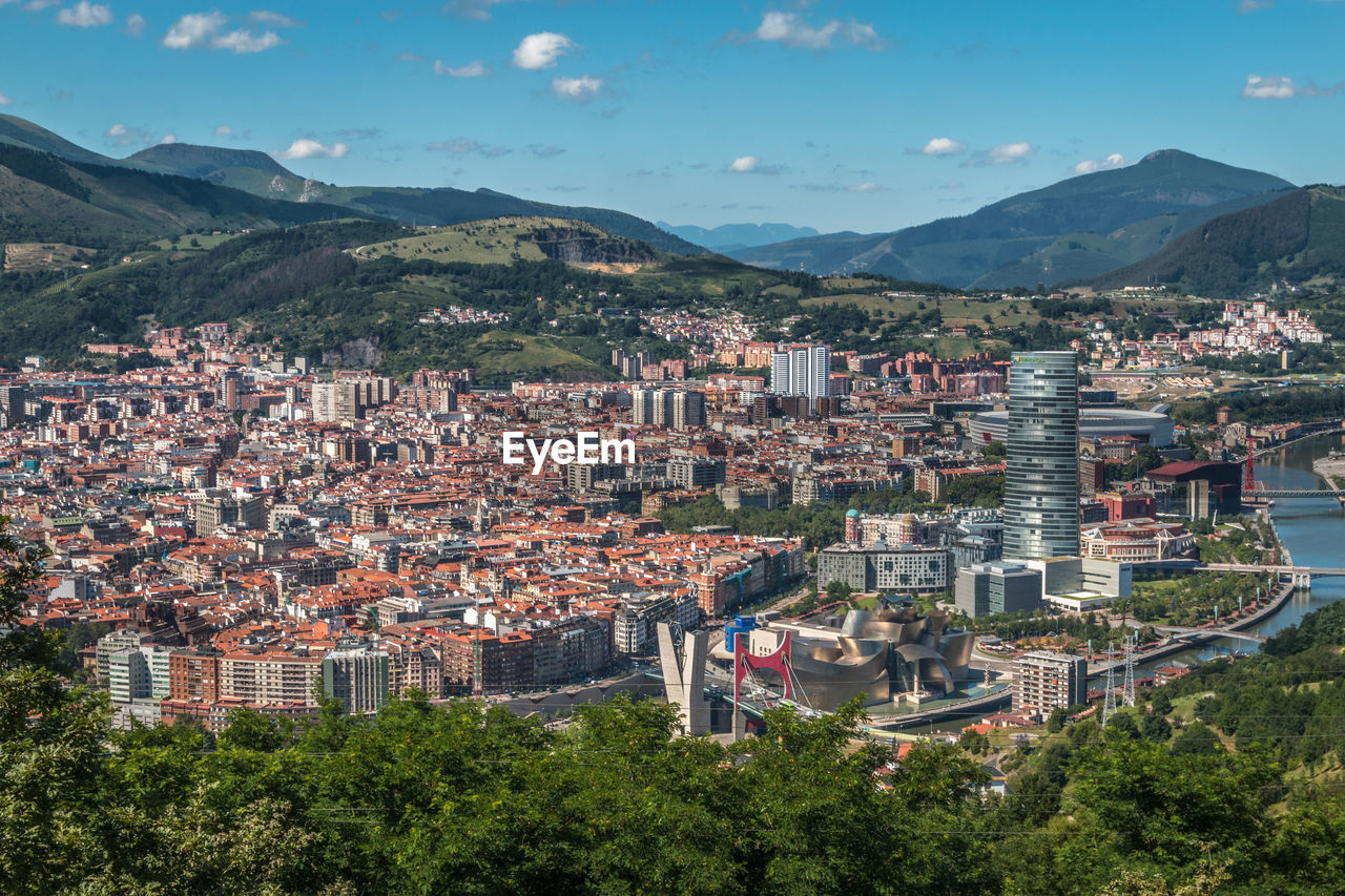 High angle view of townscape and mountains against sky