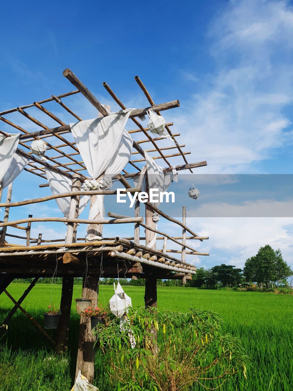 Traditional windmill on field against sky