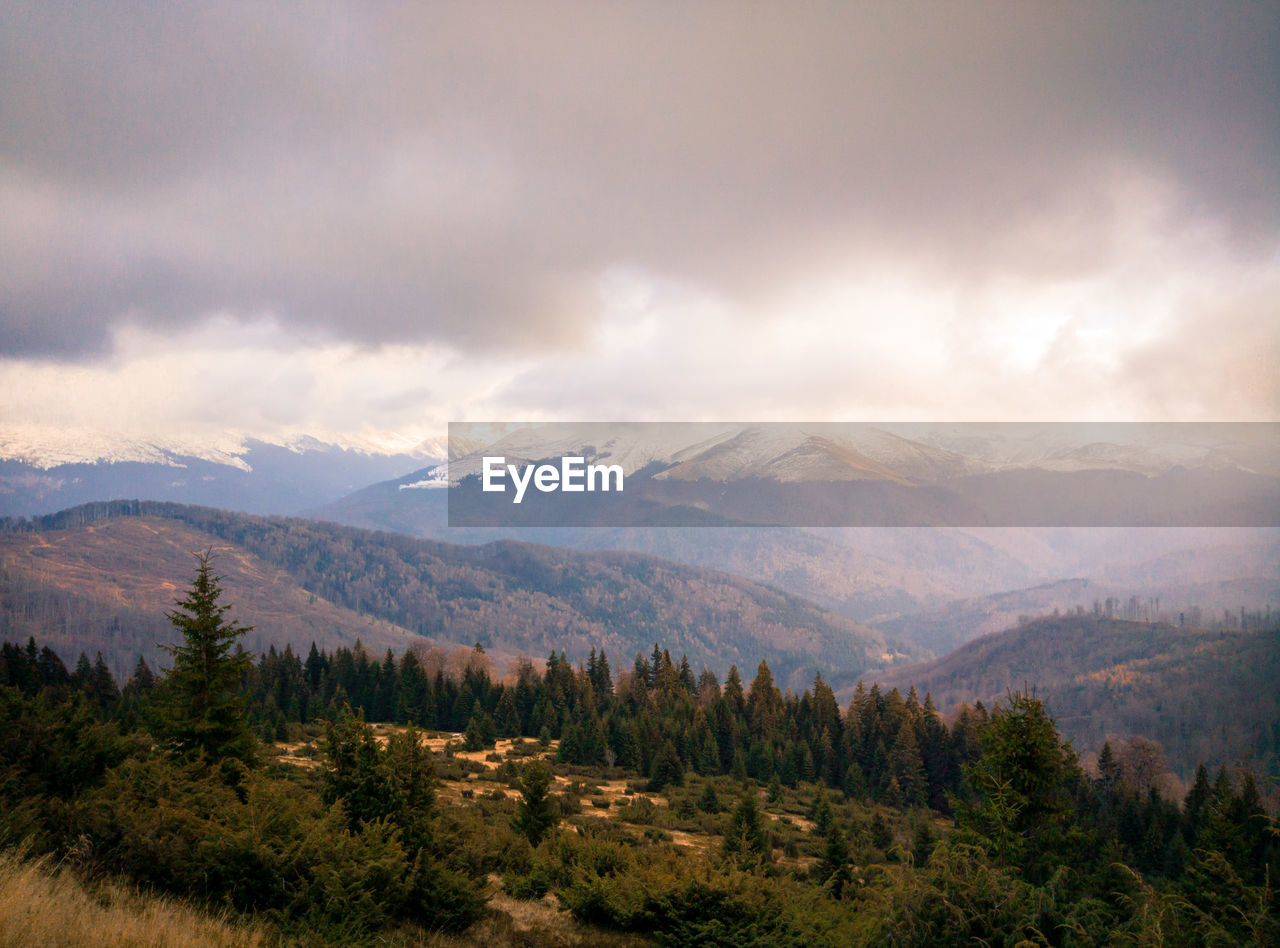Scenic view of mountains against cloudy sky