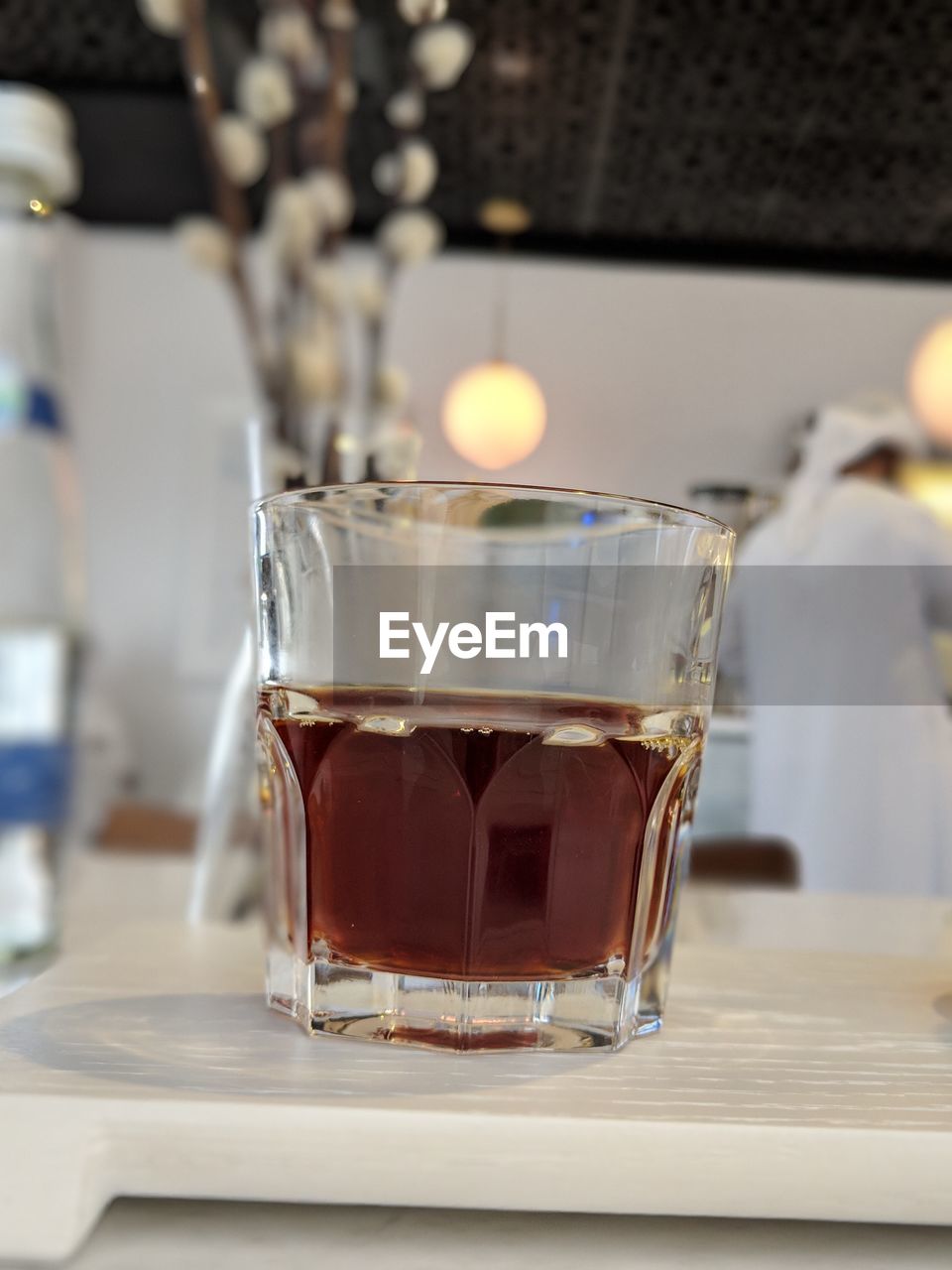 CLOSE-UP OF COFFEE IN GLASS