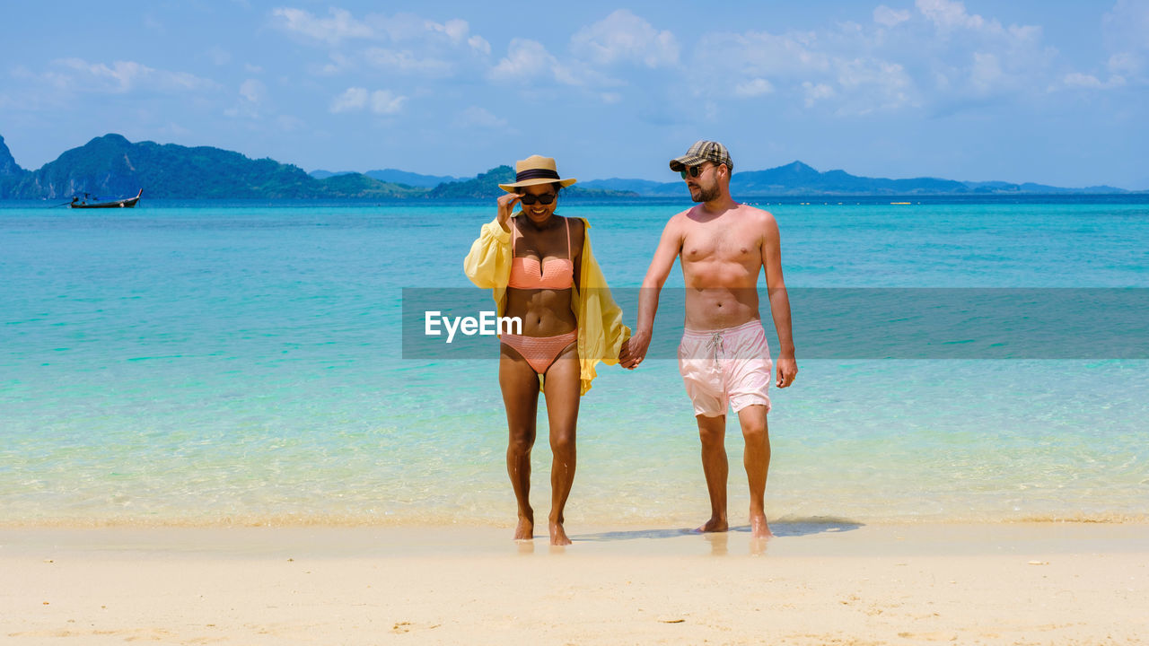 rear view of man standing at beach