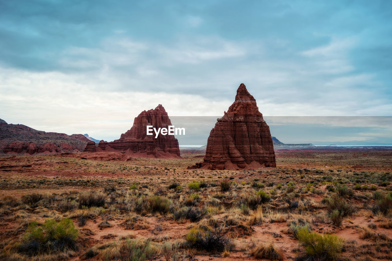 Rock formations on landscape against sky