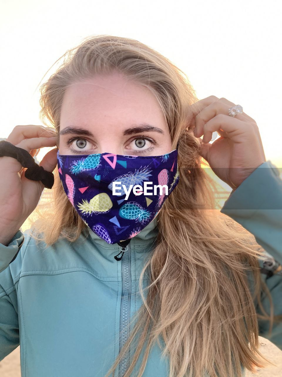 Close-up of woman wearing mask against clear sky