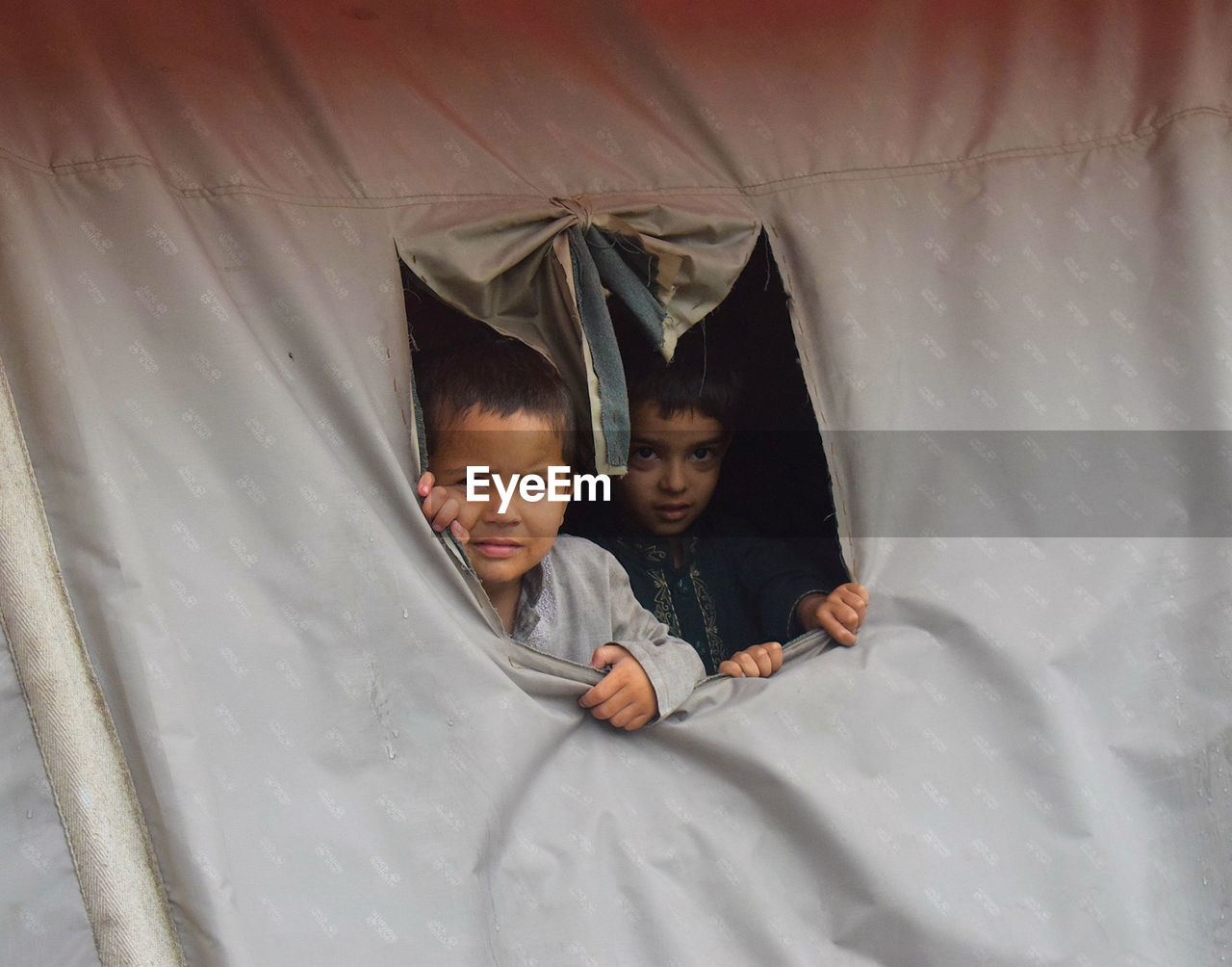 Portrait of cute boys in tent