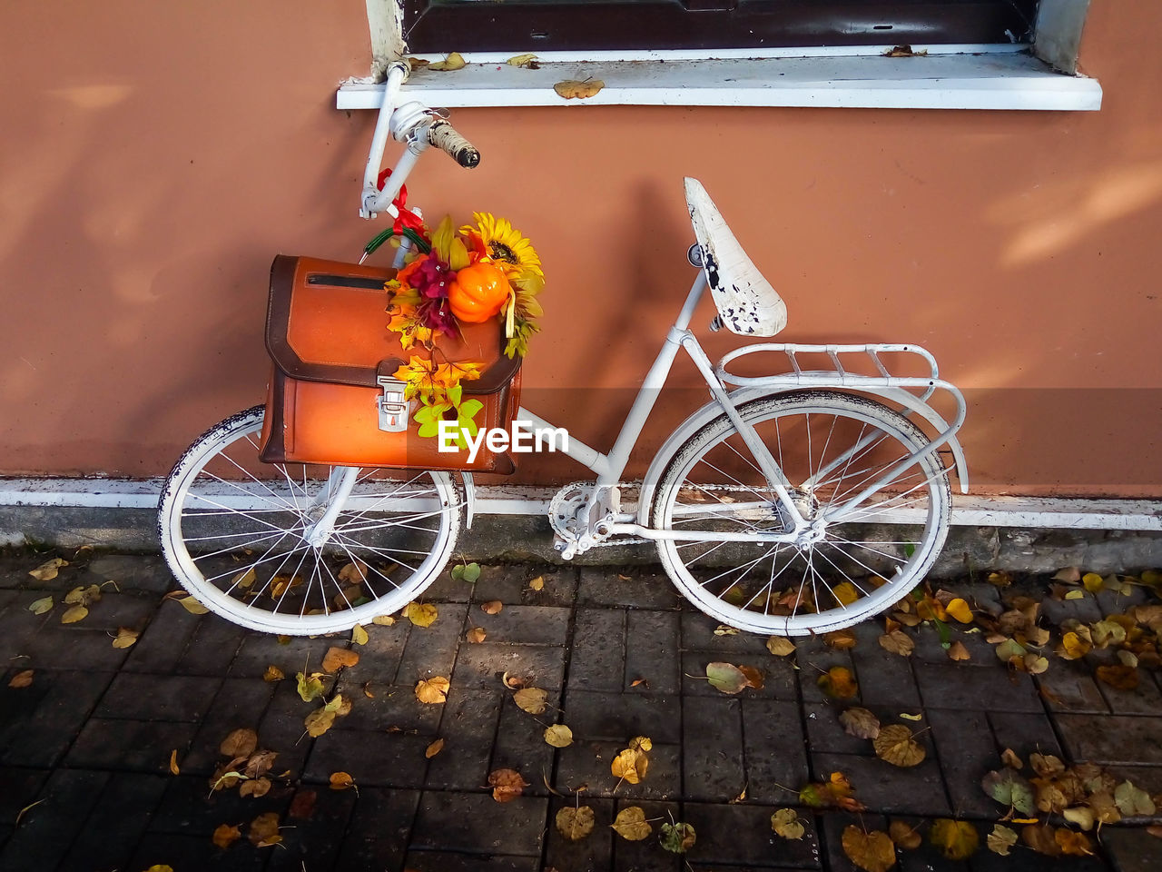 BICYCLE PARKED ON YELLOW WALL