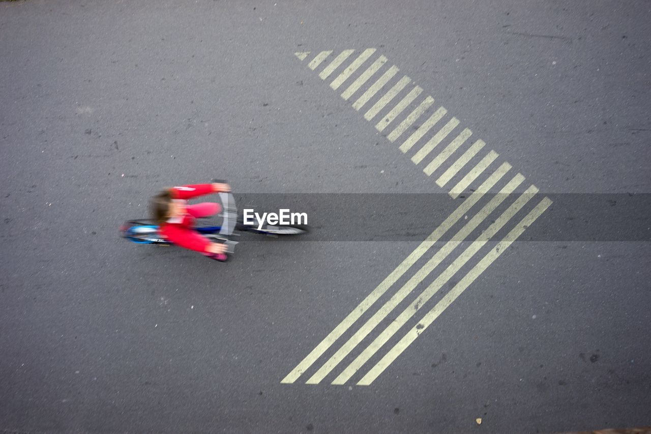 High angle view of person riding bicycle on road