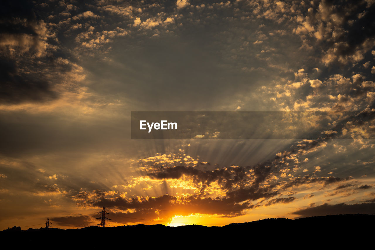 LOW ANGLE VIEW OF DRAMATIC SKY OVER SILHOUETTE LANDSCAPE