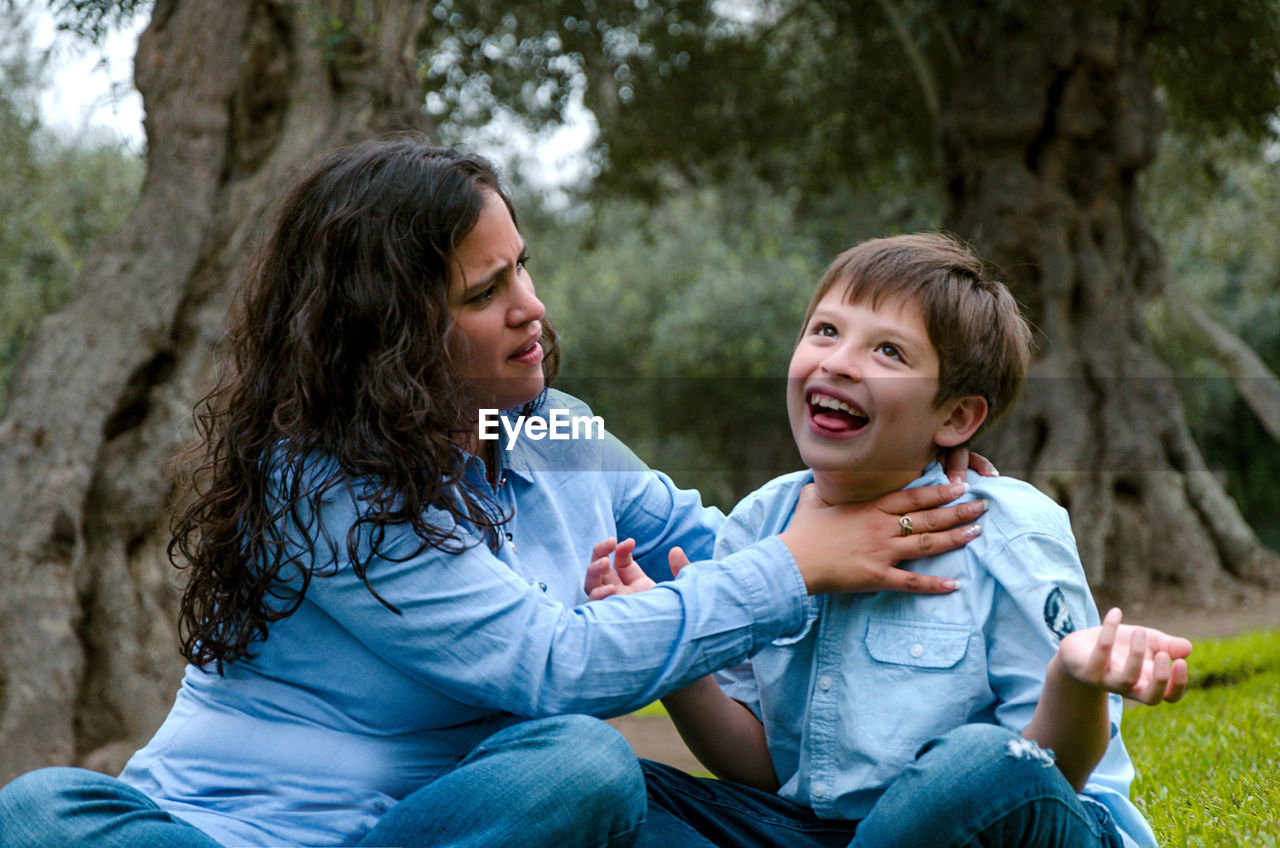 Woman playing with son at park