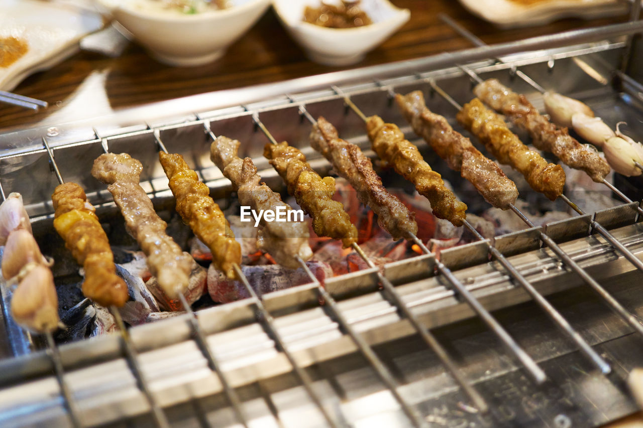 Close-up of meat skewers on barbecue grill