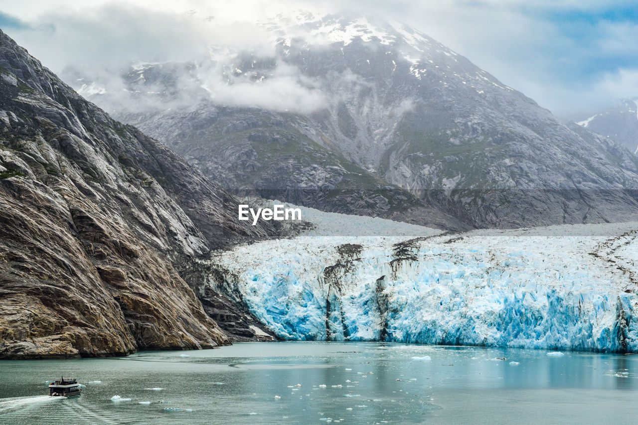 Scenic view of lake and mountains against sky at the dawes glacier in alaska 