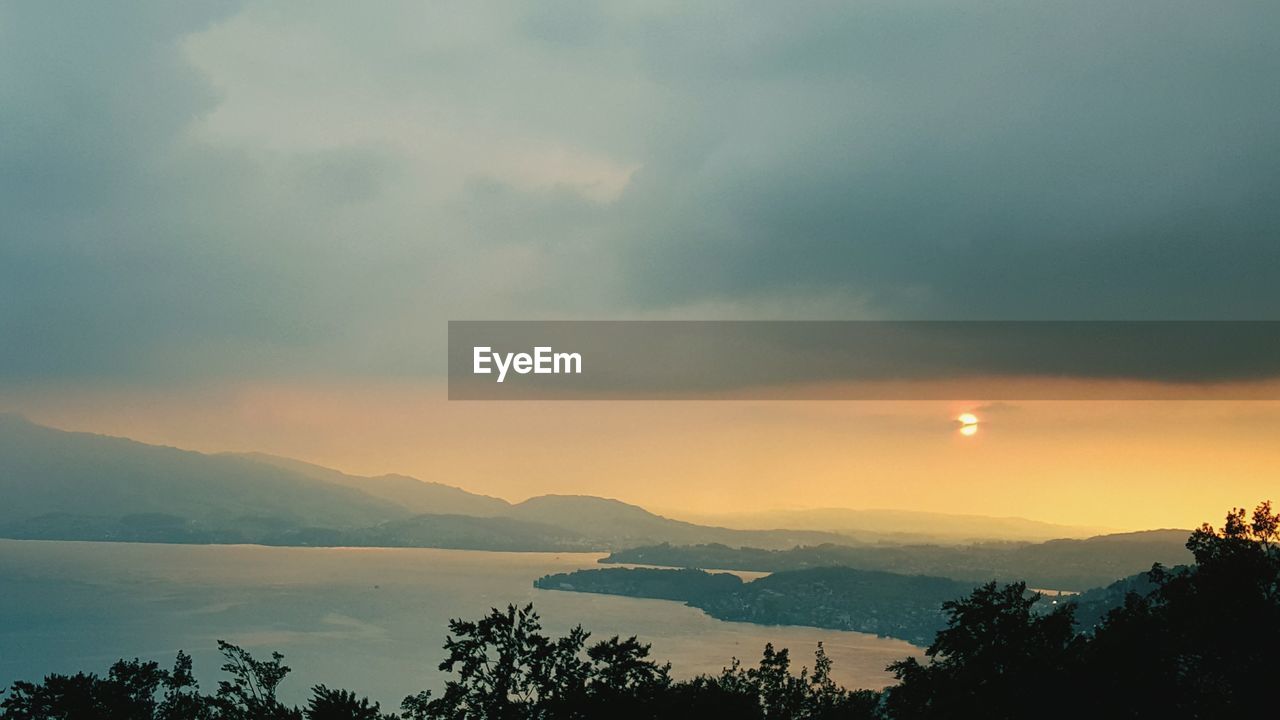 Scenic view of mountains against cloudy sky