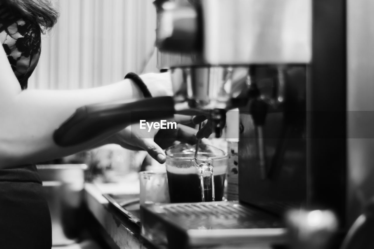 Barista making fresh coffee for service to customer