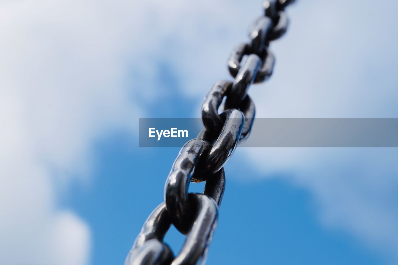 Strong steel chain for industry, blue background
