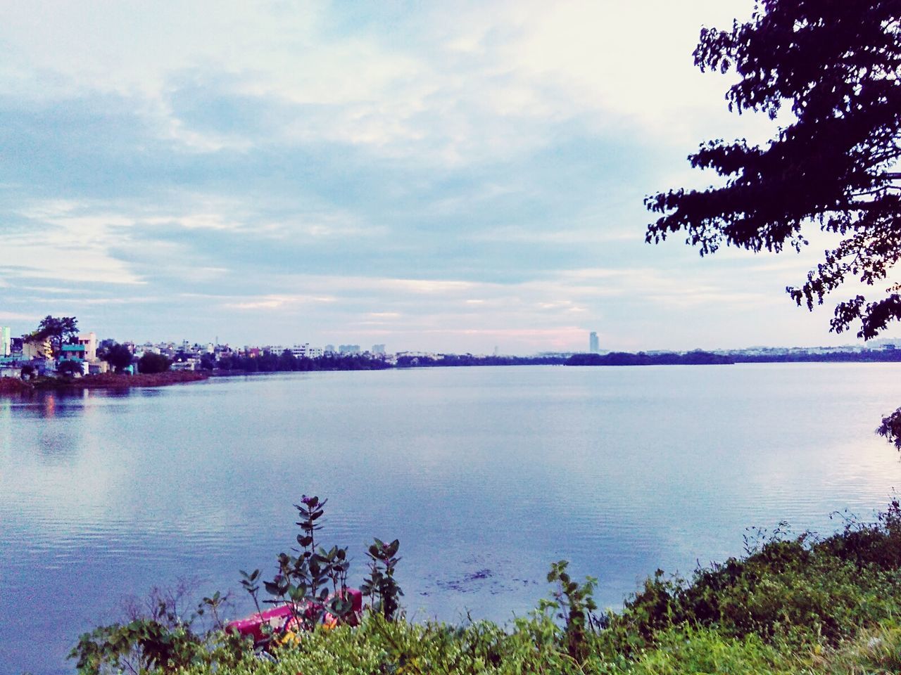 Scenic view of lake against cloudy sky