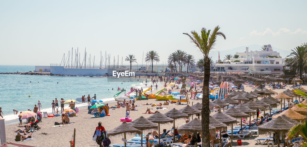 Holidaymakers sunbathing on venus beach, marbella city, province of malaga, spain, western europe.