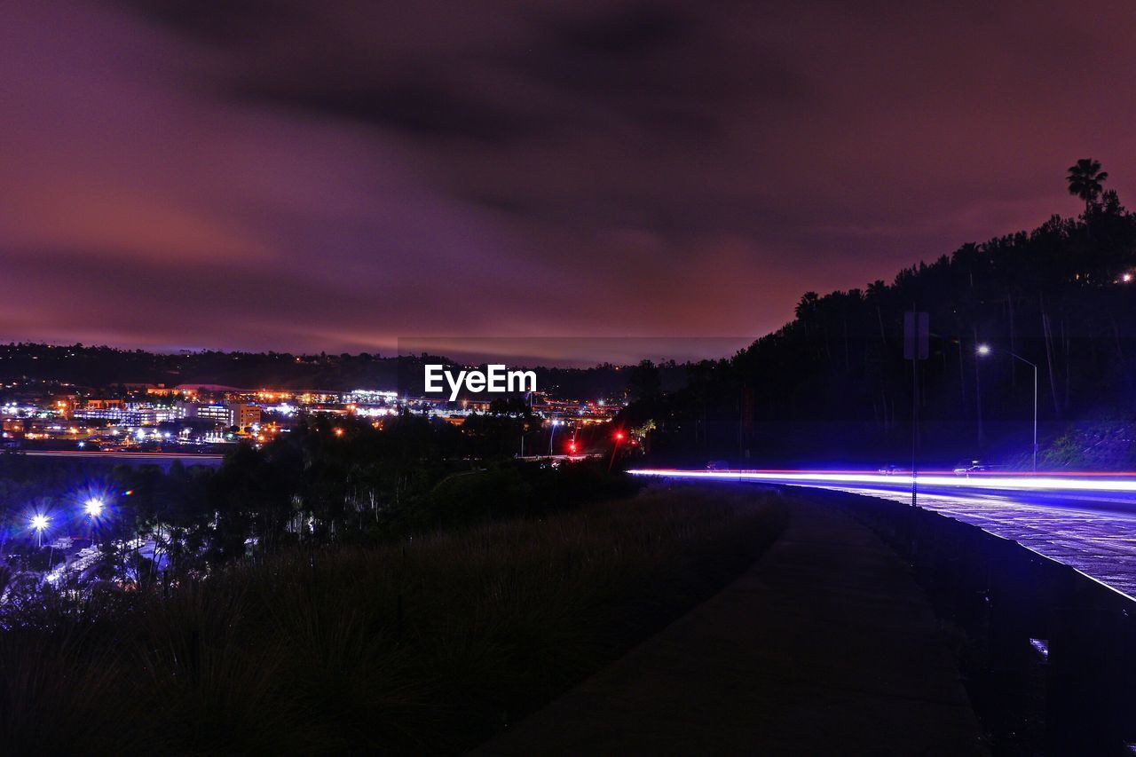 VIEW OF ILLUMINATED CITY AT NIGHT