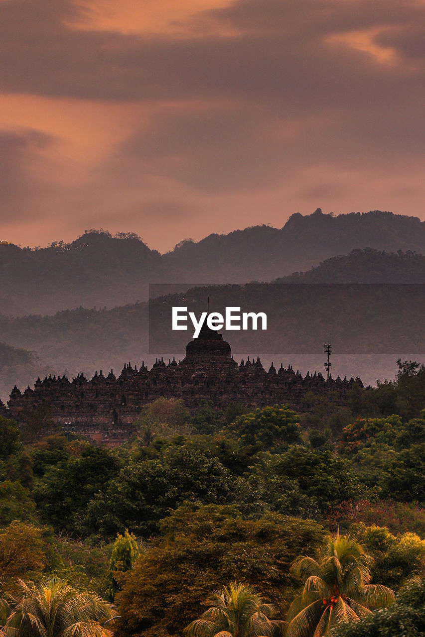 Scenic view of mountain against cloudy sky