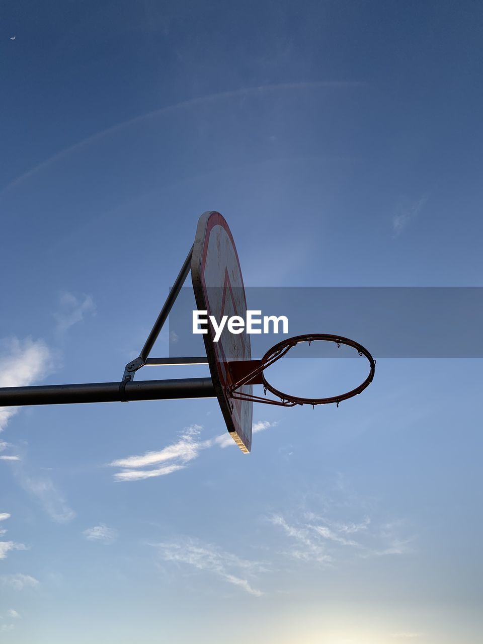 LOW ANGLE VIEW OF BASKETBALL COURT AGAINST BLUE SKY