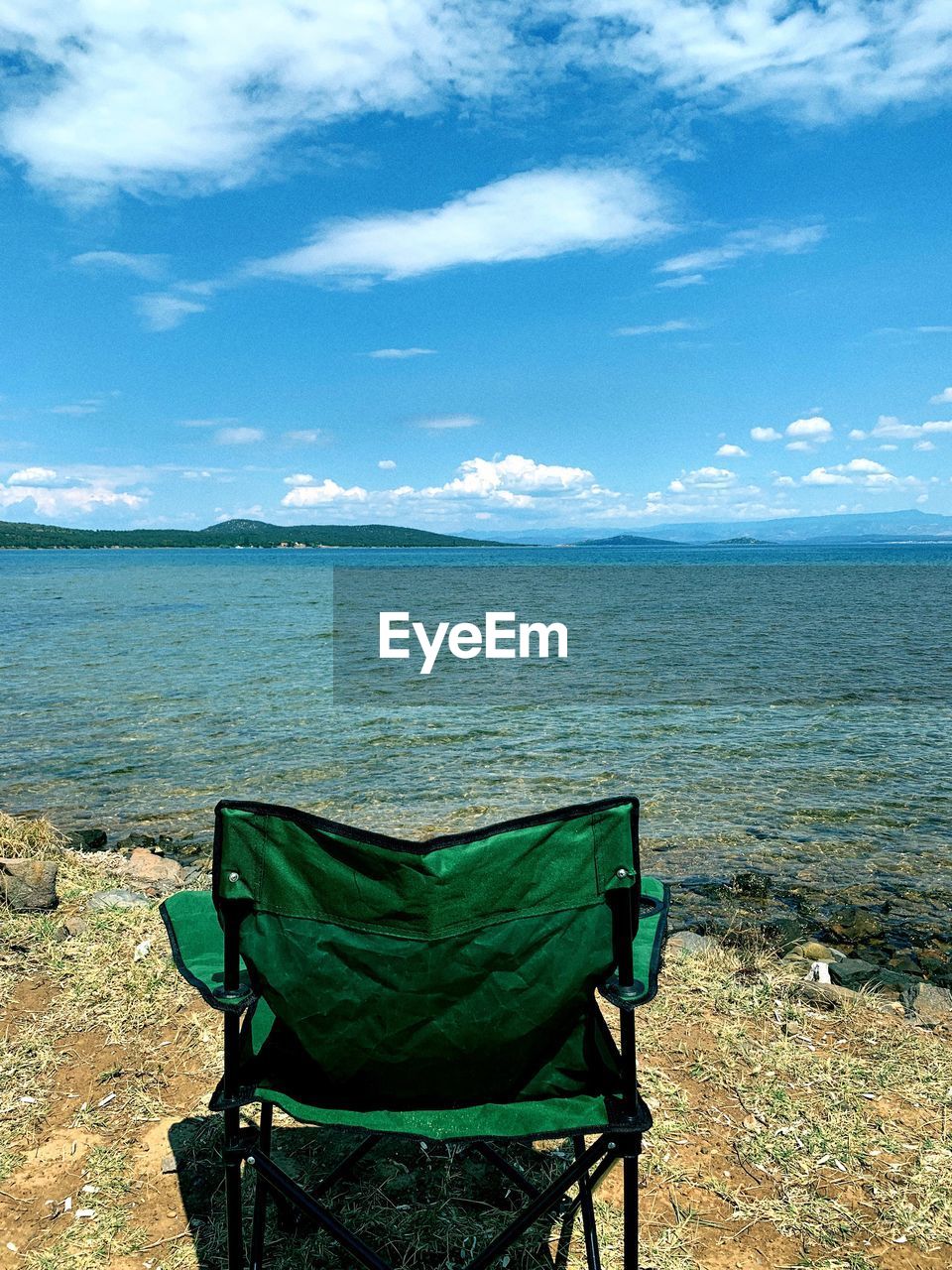 CHAIR ON BEACH AGAINST SKY