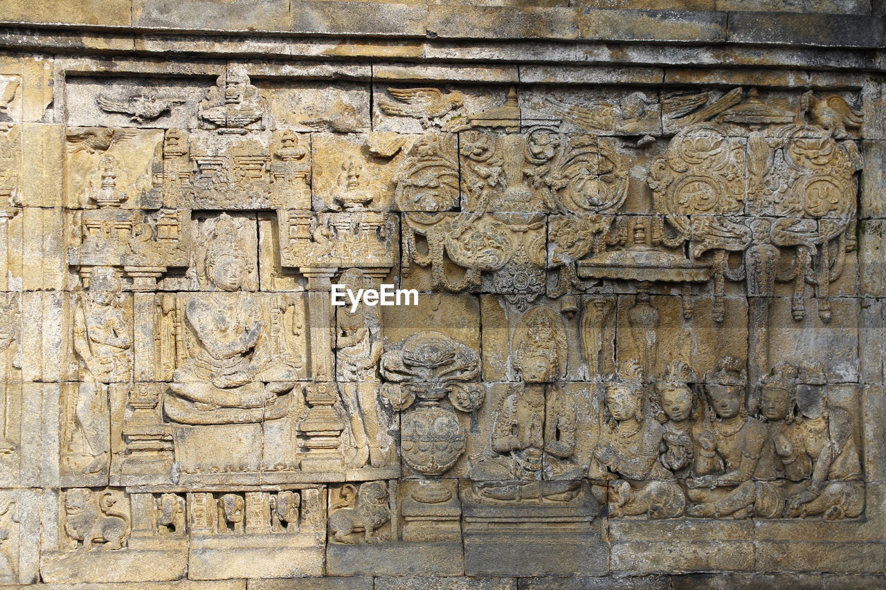 Beautiful bas-relief wall decor carved in stone at borobudur temple, yogyakarta, indonesia