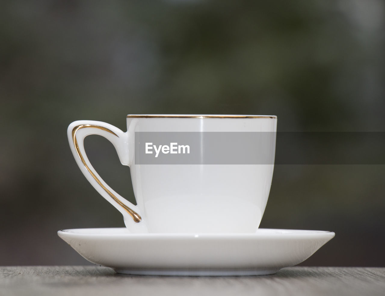 CLOSE-UP OF COFFEE CUP ON TABLE WITH SPOON