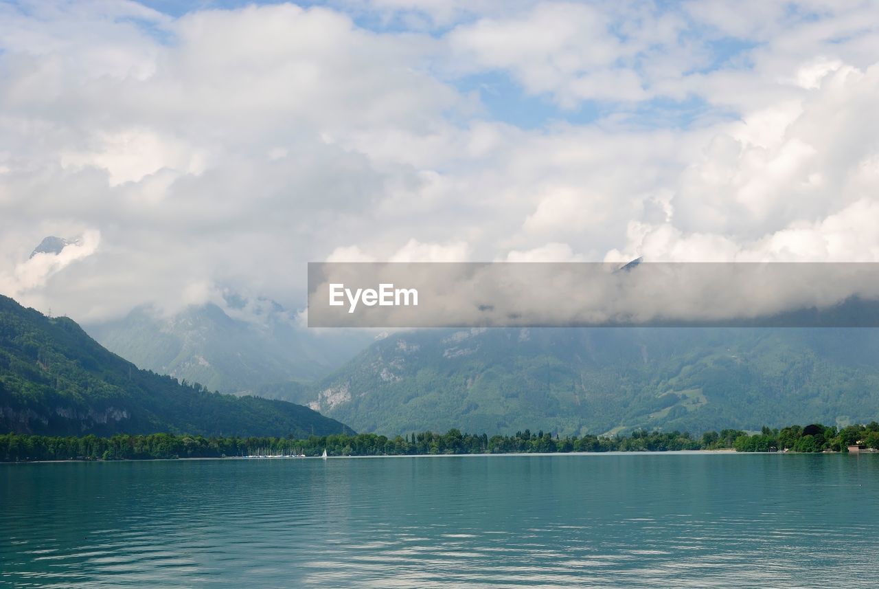 View of calm lake against cloudy sky