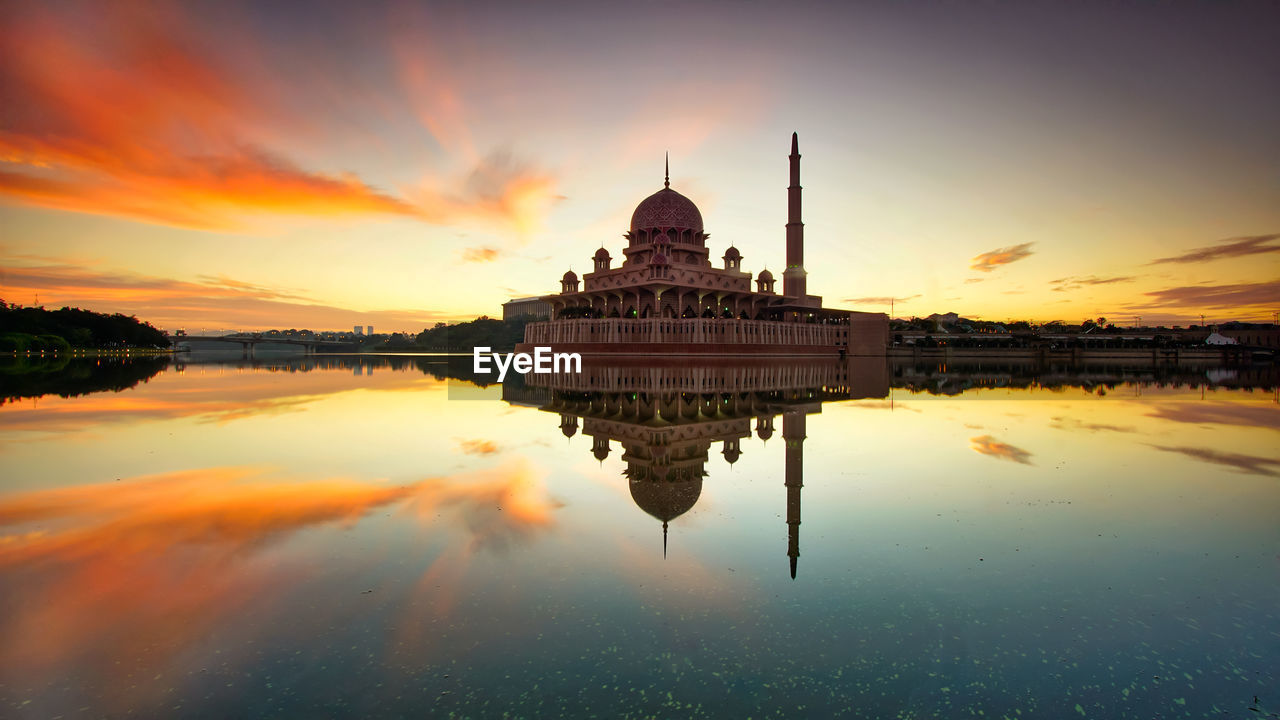 Putra mosque in lake against sky during sunset